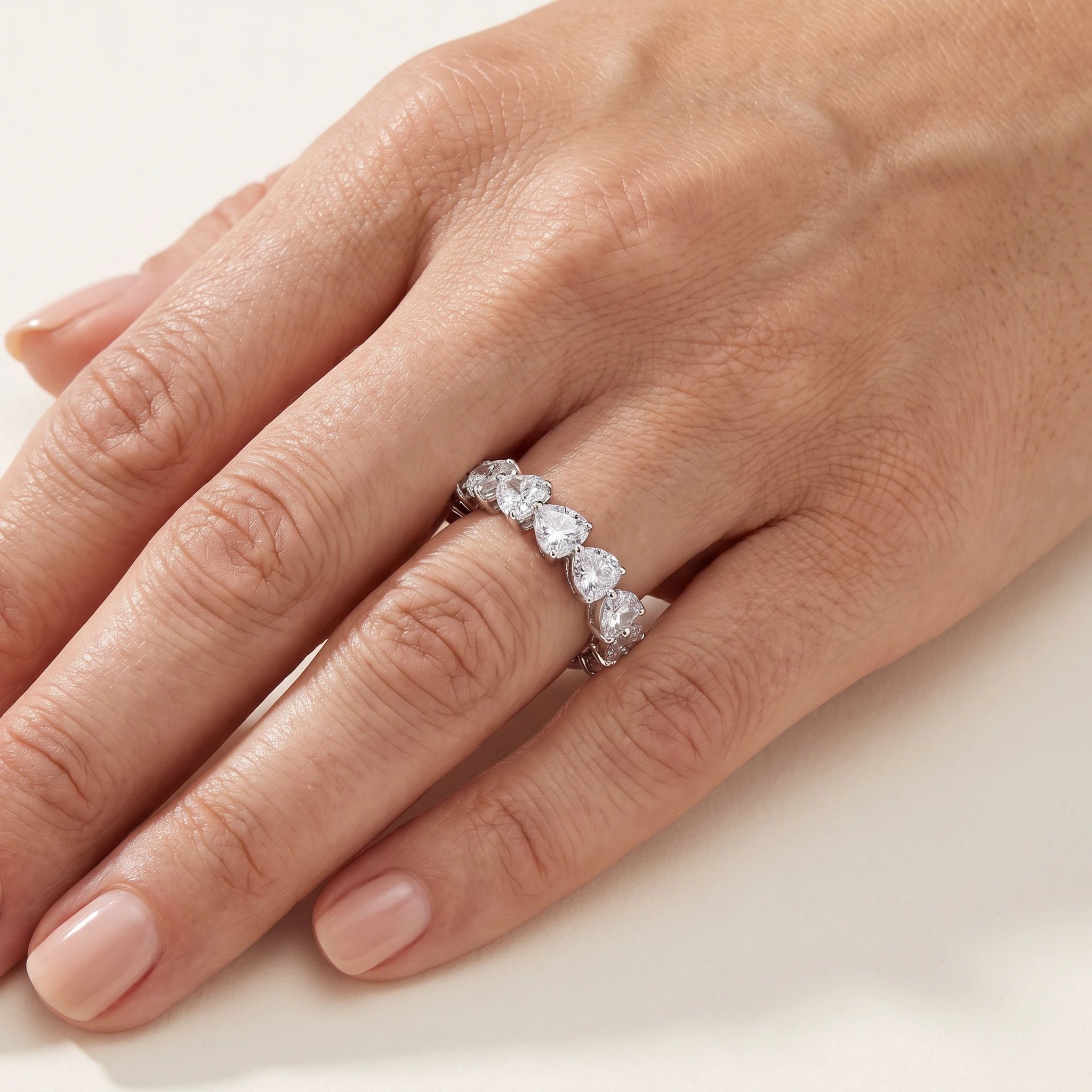 Heart-Shaped Lab-Grown Diamond Full Eternity Ring — worn on an adult hand; AI-generated style illustration