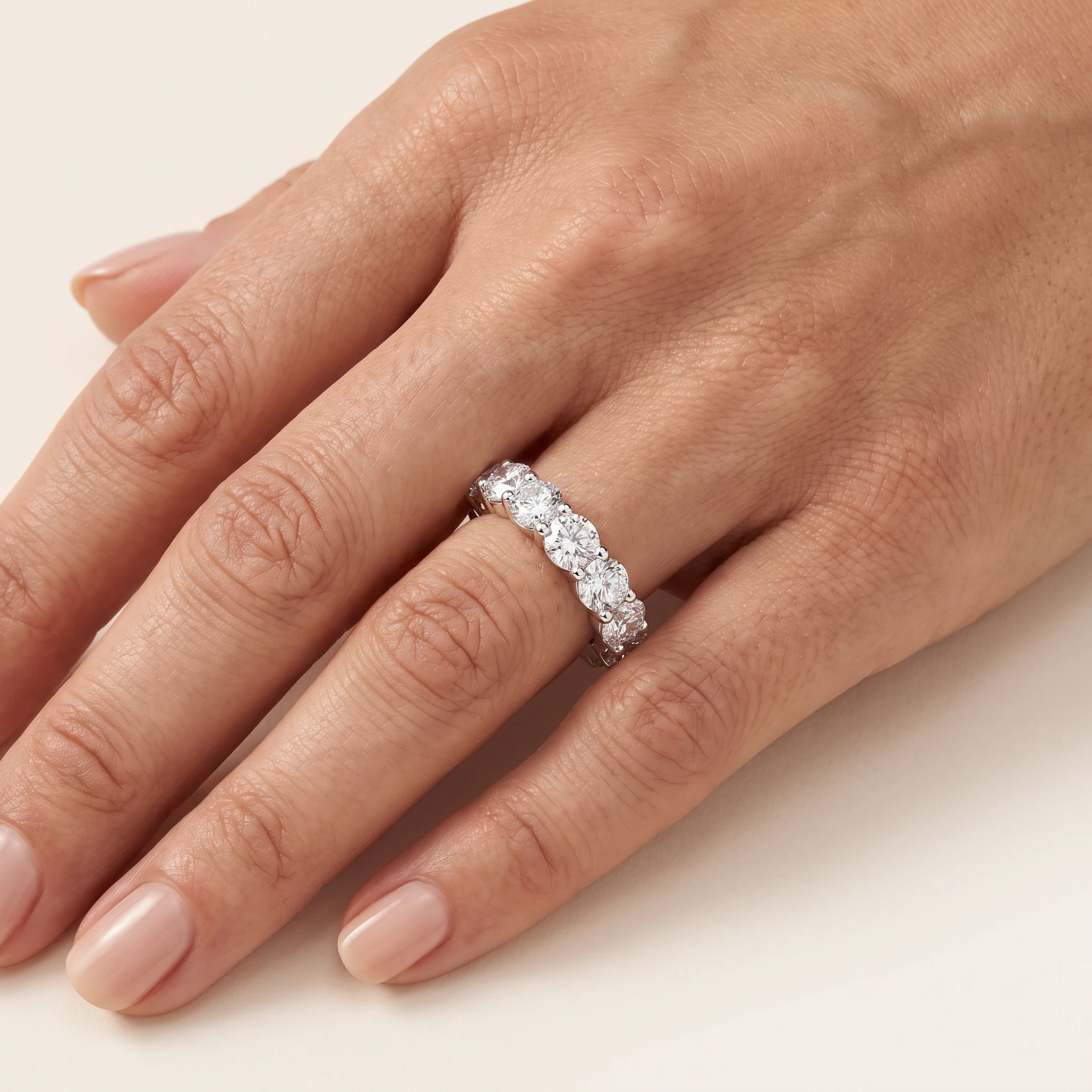 Round Lab-Grown Diamond Full Eternity Ring — worn on an adult hand; AI-generated style illustration