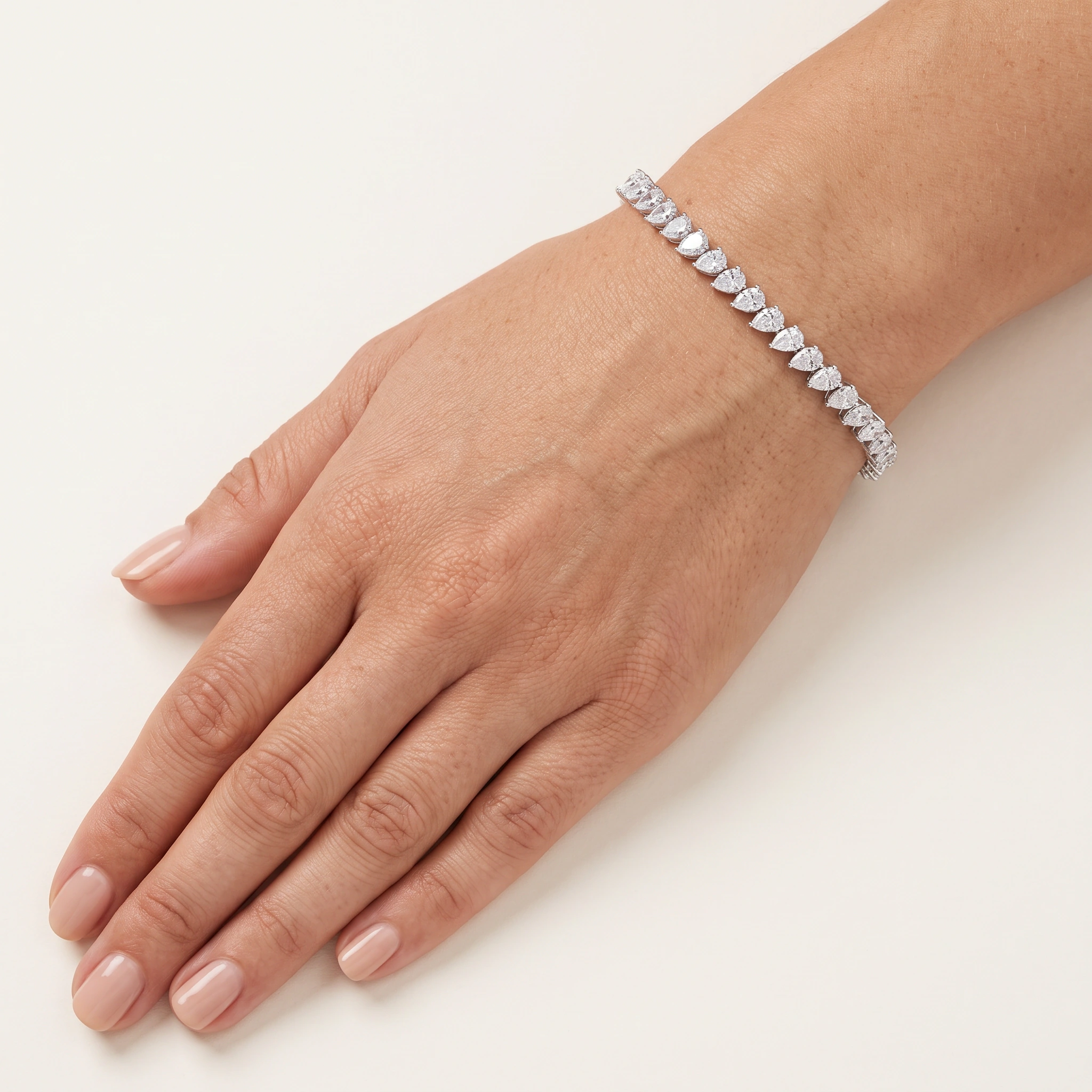Pear-Shaped Lab-Grown Diamond Tennis Bracelet — worn on an adult hand; AI-generated style illustration